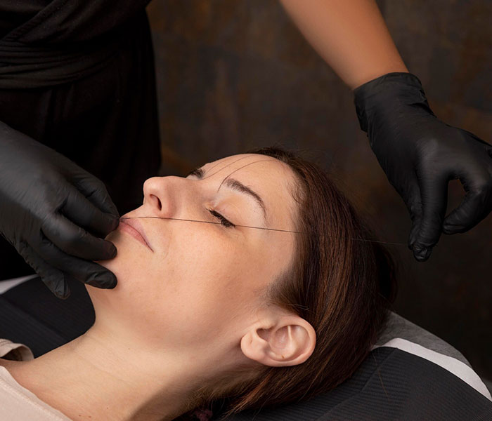 Client receiving brow threading service at Hair & Beauty by Deepawali salon in Pakenham